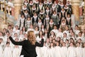 Shallow depth of field selective focus image with a choir conductor during a live concert