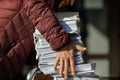 Shallow depth of field selective focus image with the hands of a man picking up a pile of files