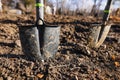 Shallow depth of field selective focus image with a metal shovel on a piece of agricultural plowed land