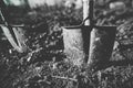Shallow depth of field selective focus image with a metal shovel on a piece of agricultural plowed land