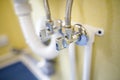 Shallow depth of field selective focus image with a metal water tap under a sink Royalty Free Stock Photo