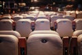 Shallow depth of field selective focus image with numbered chairs inside a theatre/cinema