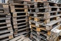 Shallow depth of field selective focus image with a pile of wooden EPAL Euro pallets stacked outdoors Royalty Free Stock Photo