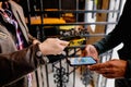 Shallow depth of field selective focus image with a restaurant client showing a Covid-19 certificate from a mobile phone to an