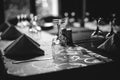 Shallow depth of field selective focus image with a restaurant table ready to receive customers. Empty glasses and tableware