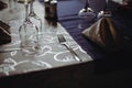 Shallow depth of field selective focus image with a restaurant table ready to receive customers. Empty glasses and tableware