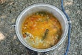 Shallow depth of field selective focus image with a traditional Danube Delta fish soup in a big iron cast cauldron Royalty Free Stock Photo