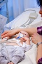 Shallow depth of field of sick infant boy undergoing a electrocardiography to check his heart.