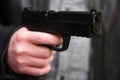 Shallow DOF image of a criminal brandishing a gun.