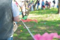 Shallow DOF long line of diverse parents kids near pennant tape barricade line waiting for Easter egg hunting tradition Royalty Free Stock Photo