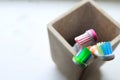 Shallow DOF shot of three toothbrushes in a clay tumbler in the morning light Royalty Free Stock Photo