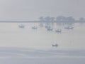 Shallow fishing boats anchor at the beach on thick fog days. Royalty Free Stock Photo