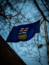 Shallow focus of a blue Albertan flag waving on the building of government, Alberta, Canada