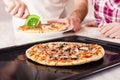 Shallow focus closeup shot of people cutting delicious homemade pizza