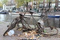 Shallow focus closeup shot of a rusty bicycle near the canal in Amsterdam, the Netherlands