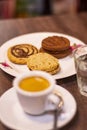 Shallow focus of cockies pastry, a cup of coffee and a glass of water on a table Royalty Free Stock Photo