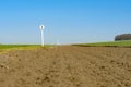 Shallow focus of a 1 furlong sign seen next to a race horse training track seen from ground level. Royalty Free Stock Photo