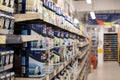 Shallow focus of large tins of DIY paint seen within a well-known DIY store.