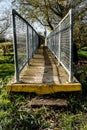 Shallow focus of locked, industrial footbridge, with detail of the fencing and non-slip footpath. Royalty Free Stock Photo