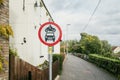 Shallow focus of a No Entry sign for motor vehicles seen down a very narrow urban stree Royalty Free Stock Photo