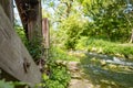 Shallow focus of an old abandoned timber built structure seen next to a fast flowing river.