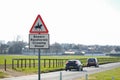 Shallow focus of a road warning sign, warning drivers of nearby racehorses. Royalty Free Stock Photo