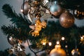 Shallow focus shot of beautiful baubles and string lights hanging on a Christmas tree