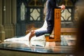 Shallow focus shot of a bride and groom kneeling on a prayer kneeler inside the church Royalty Free Stock Photo