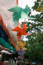 Shallow focus shot of colorful Pinwheels hanging with blur background in the street Royalty Free Stock Photo