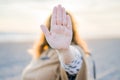 Shallow focus shot of a female hand gesturing a stop sign Royalty Free Stock Photo