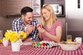 Shallow focus shot of a happy family painting Easter eggs in joy Royalty Free Stock Photo