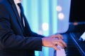 Shallow focus shot of a male pianist playing on a luxury event