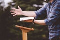 Shallow focus shot of the open palm of a male giving a speech