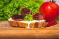 Shallow focus shot of rolls of cold-cut meat on a toasted bread dripping with cream Royalty Free Stock Photo