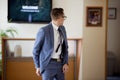 Shallow focus shot of a white male wearing a suit and tie attire looking back in a room Royalty Free Stock Photo