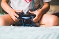 Shallow focus shot of a young boy playing computer games with a joystick Royalty Free Stock Photo