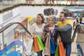 Shallow focus shot of young Caucasian friends on an escalator in a mall Royalty Free Stock Photo