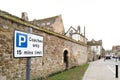 Shallow focus sign of a a Coach Only stop seen outside a historical city within the United Kingdom. Royalty Free Stock Photo