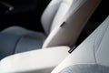 Shallow focus of an SRS Airbag tag seen attached to front part leather seats in a hybrid, new technology vehicle. Royalty Free Stock Photo