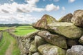 Shallow focus of stacked stones making up part of a very old meadow stone wall in the heart of the Yorkshire Dales.