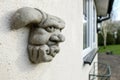 Shallow focus of a stonework gargoyle on an outside wall. Royalty Free Stock Photo