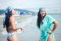 Shallow focus of two beautiful Hispanic women laughing and having a good day at a beach Royalty Free Stock Photo