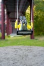 Shallow focus vertical view of a young Caucasian girl playing on a swing set Royalty Free Stock Photo