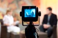 Shallow focus of a Video camera viewfinder, recording show in a TV studio during a talk show