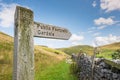 Shallow focus of a wooden public footpath sign seen at the heart of the Yorkshire Dales. Royalty Free Stock Photo