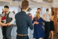 Shallow focus of a young photographer filming a wedding in a restaurant