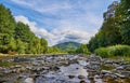 Shallow mountain river on a summer day. Rocky bottom exposed