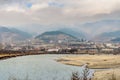 A Shallow River is Flowing Through a Poor Village in South Bulgaria, Balkans, Europe. Mountain Tops Fade in Fod at Winter Season.