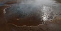 Shallow steaming geysir in Iceland surrounded my minerals Royalty Free Stock Photo