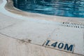 Shallow swimming pool at a hotel. Warning sign with deepness level near pool entrance. Learning or teaching children how to swim. Royalty Free Stock Photo